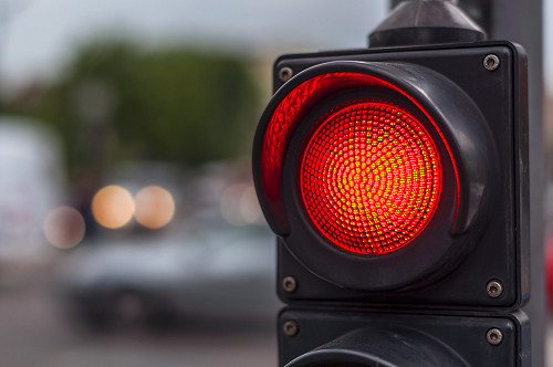 A stop and go light shows red.