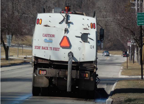 A City of Sheboygan street sweeping truck clears a road.